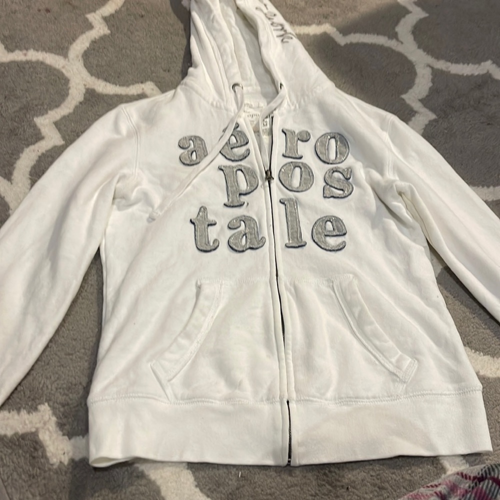 Aeropostale jacket with zipper and bold bulky letters, white, silver, and black.